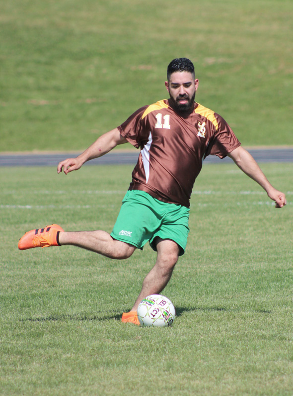 a man kicking a soccer ball at the 2019 hilltopper