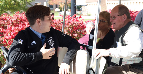 student speaking to two benefactors