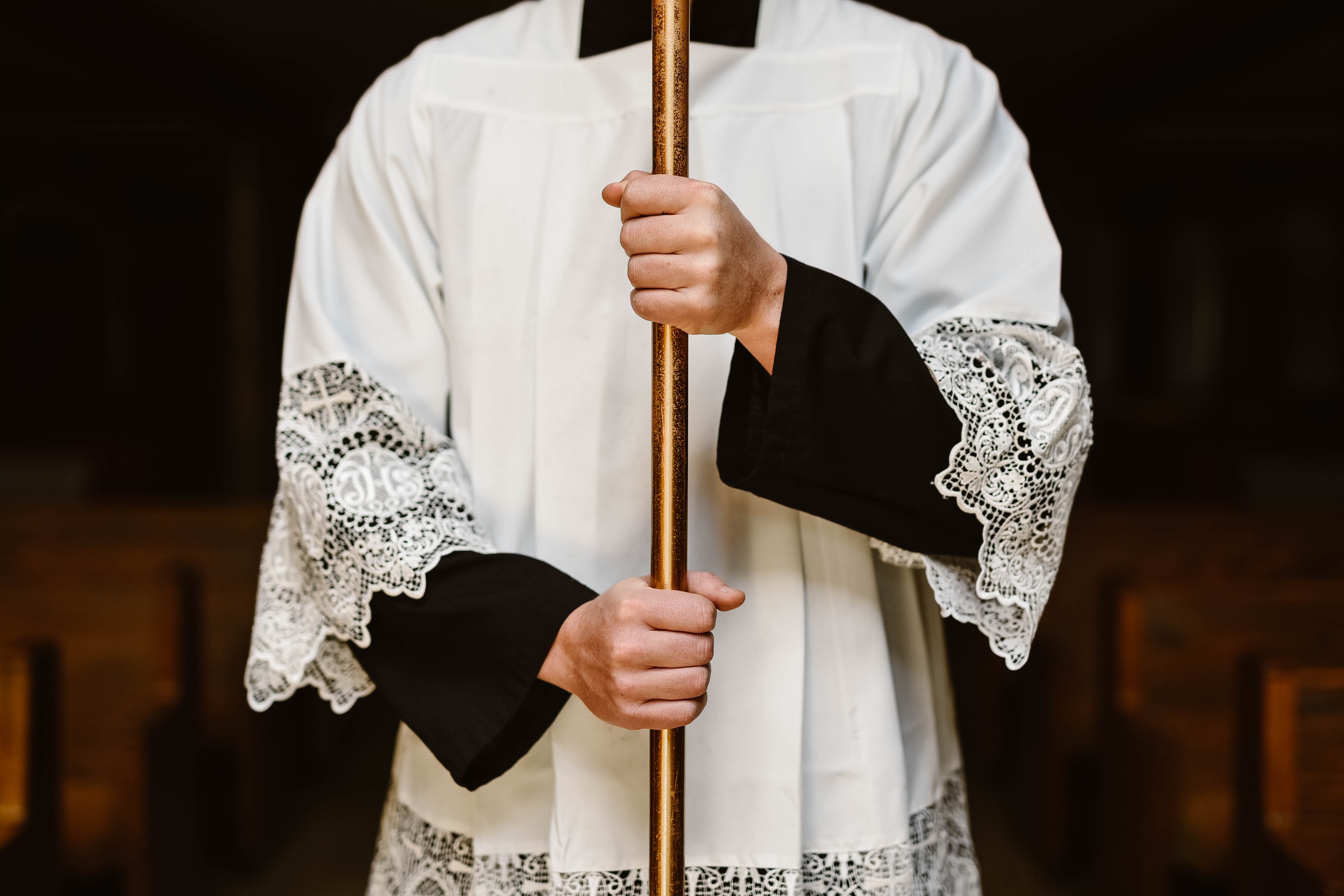 a catholic man holding a staff