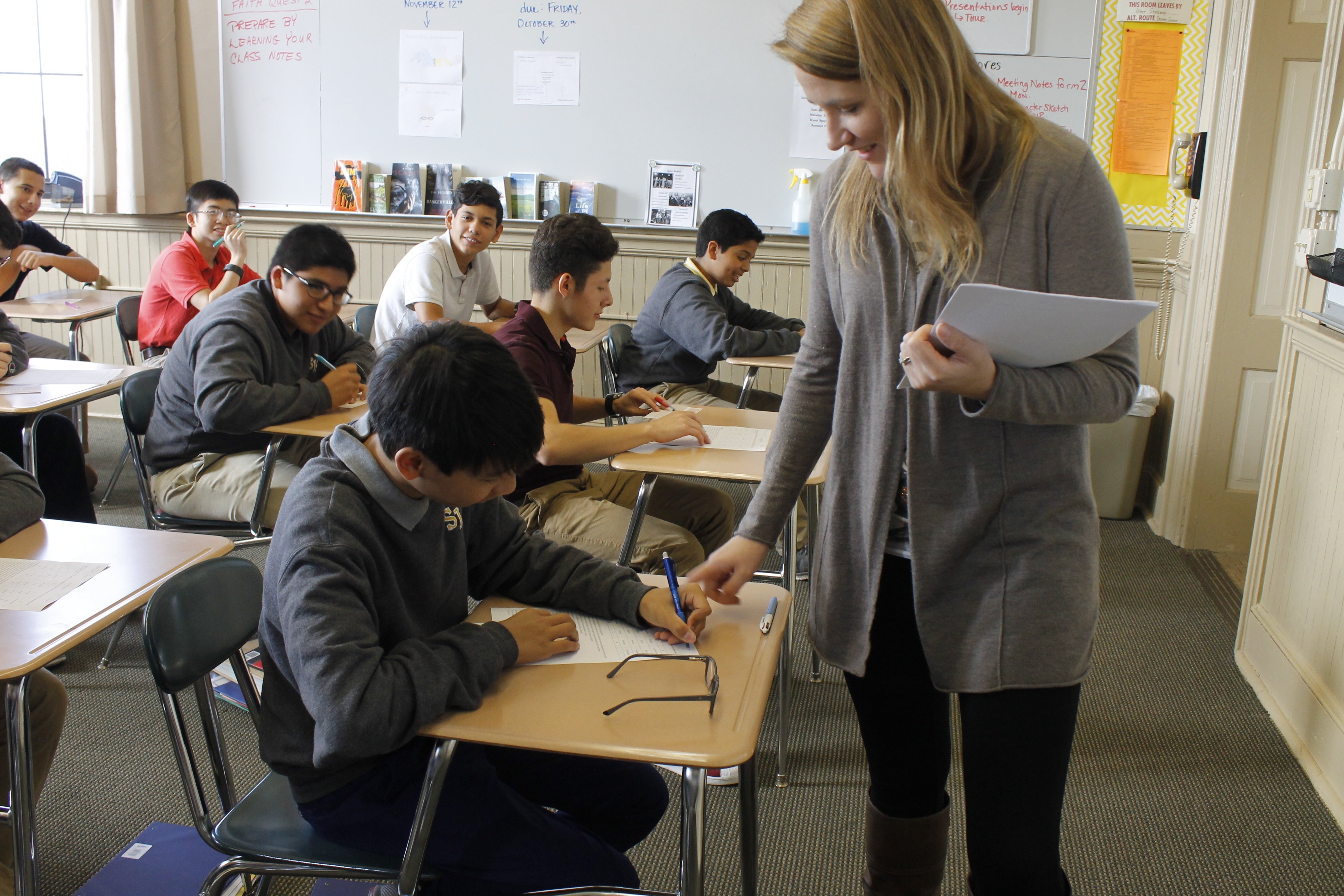 a teacher helping a student on an assignement