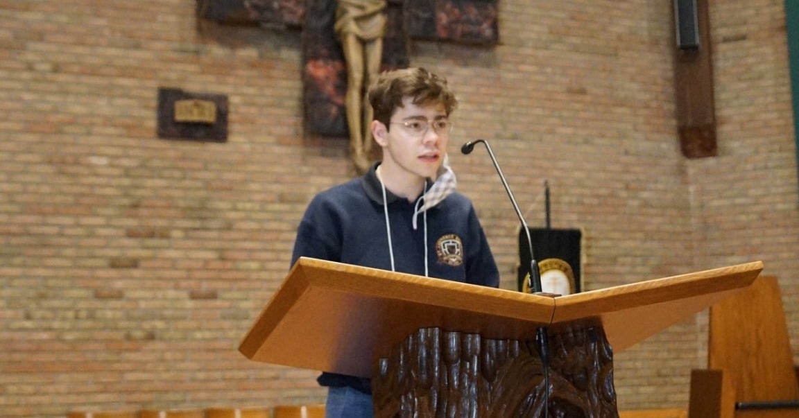 a student speaking at mass